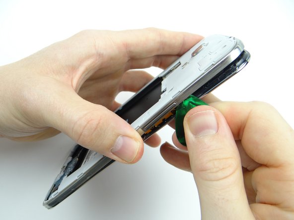 Picture 3: Reinsert the guitar pick below the volume rocker and work your way down.