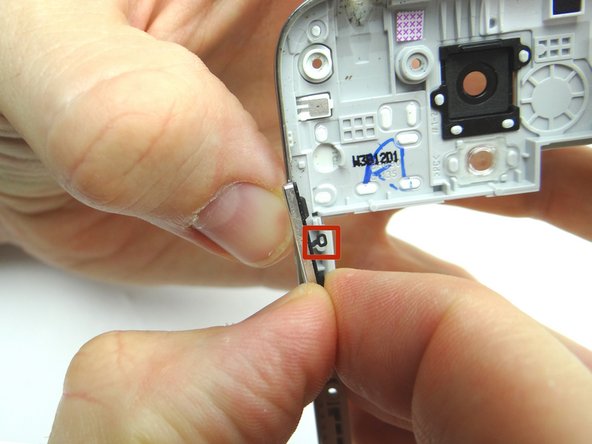 Picture 2: Make sure you don't tear the rubber attachment head as you carefully peel up from the mid-frame.