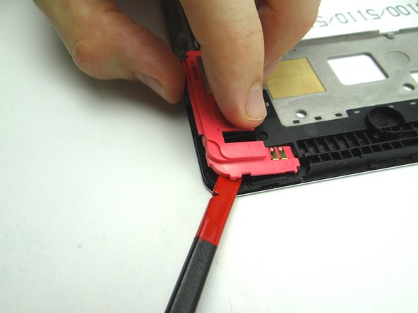 Wedge flat end of spudger under corner of loudspeaker without antenna. Pull up with your hands at the same time.