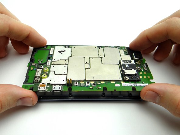 Pictures 2 &amp; 3: Lift the side of the logic board with the HDMI &amp; charging ports, opening it away from the front panel like a book.