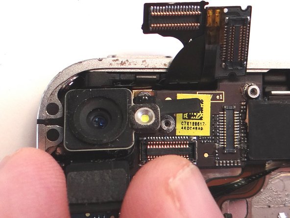 Use the flat end of the Black Spudger to gently pry three cables free from their sockets on the logic board.