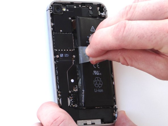 Grab battery removal tab and gently pull tab away from phone, taking care not to bend or warp the battery as you pull (you may have to use the spudger to help wedge it up).  Apply more heat in 30 second increments, if needed.