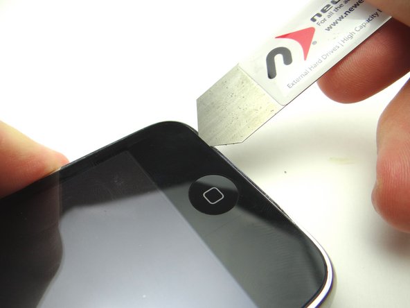 Picture 1: Wedge the iSesamo along the bottom edge of the iPhone near the corner.