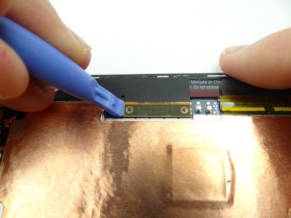 Pictures 2 &amp; 3: Use the blue pry tool to disconnect the two large daughter board flex cables from the main logic board.