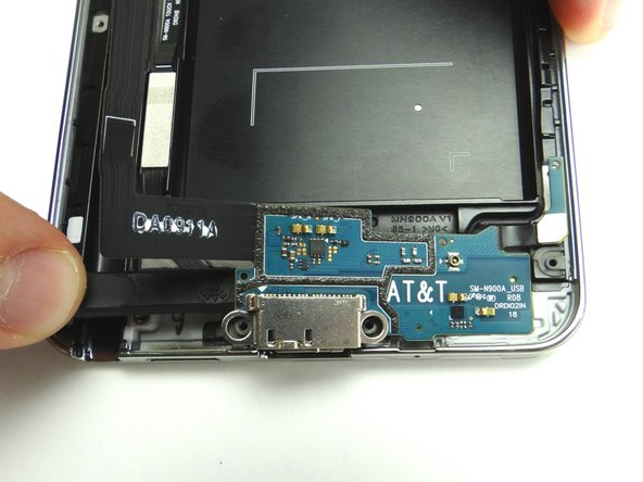 Sweep down and to the right to loosen the adhesive holding it in place.