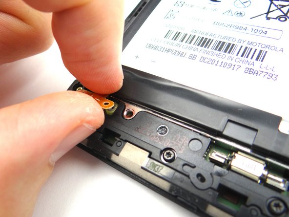 Picture 3: Gently lift the battery connector slightly above the rear case.  This helps ensure you won't damage the connector while removing the battery.