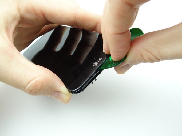 Picture 3: Heat the left side of the display, insert a third guitar pick and roll it up the left side until you reach the upper-left corner.