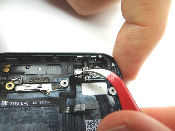 Picture 3: Use Curved Tip Tweezers to move the power button ribbon cable away from the top.