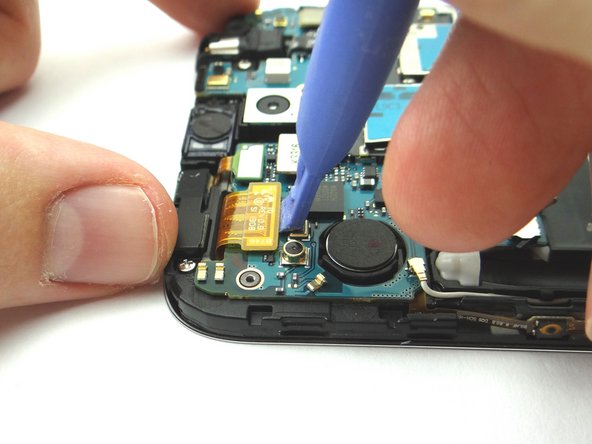 Use the Blue Pry Tool to disconnect the seven ribbon cable connectors on the logic board.