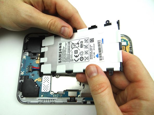 Picture 1: Lift the battery.  Hold it at a 45° angle.