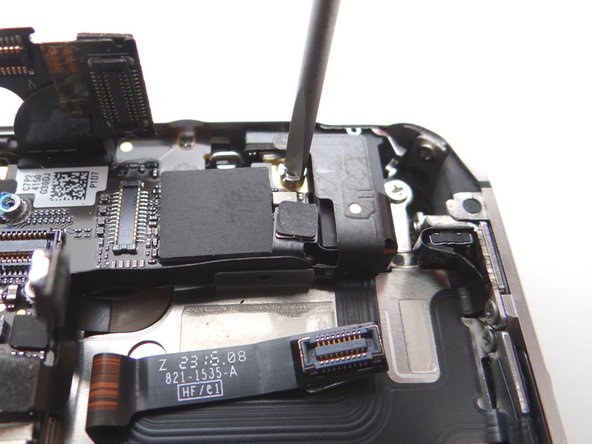 Picture 3: Use a small flathead screwdriver to remove the 4.8 mm standoff screw near the headphone jack.  Place standoff in SLOT 9 with the Phillips screw and Antenna Shield.