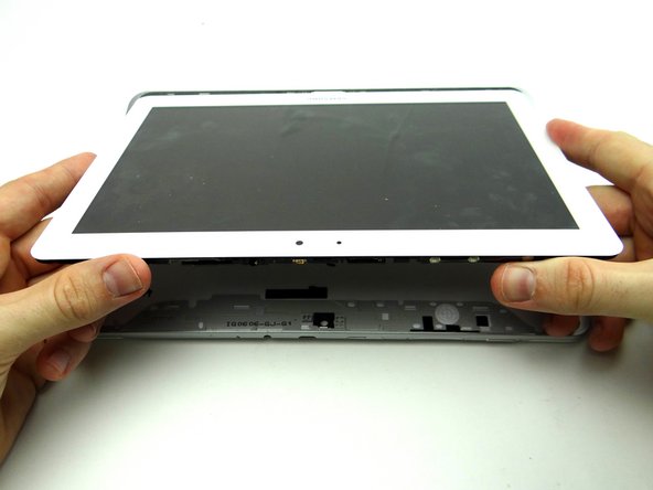 Remove the blue pry tools, then pivot the top edge of the front panel above the rear case.