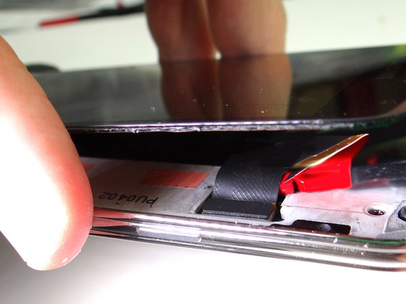 Picture 2: Use the spudger to gently lift the LCD cable from its socket.