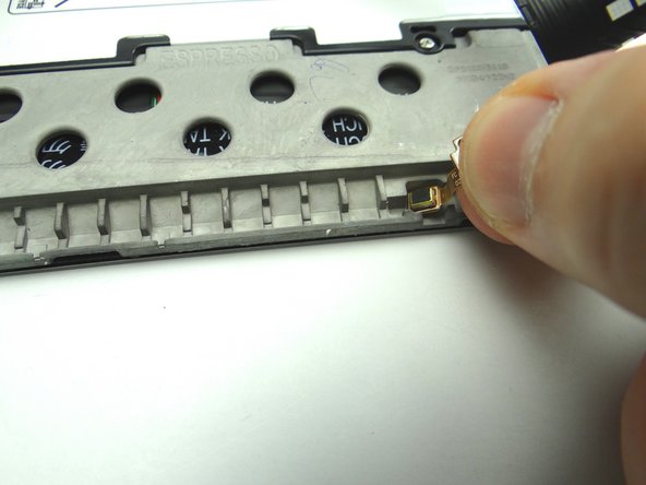 Adhesive holds the microphone (attached to the charging port) in place: