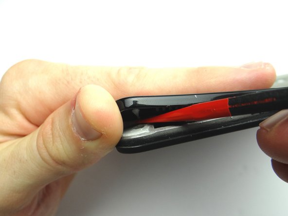 Use the flat end of the spudger to cut through it.