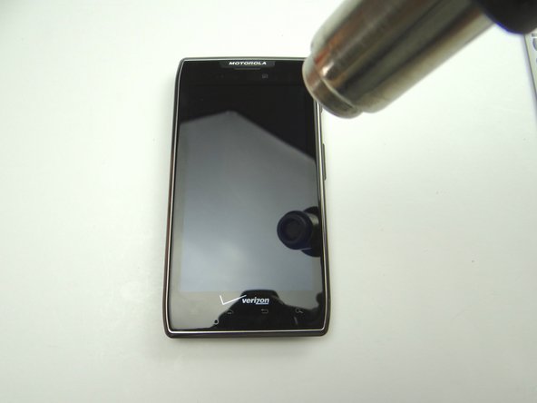 Picture 1: Apply low-level heat (100° Celsius) to the screen to loosen adhesive holding the battery in place.