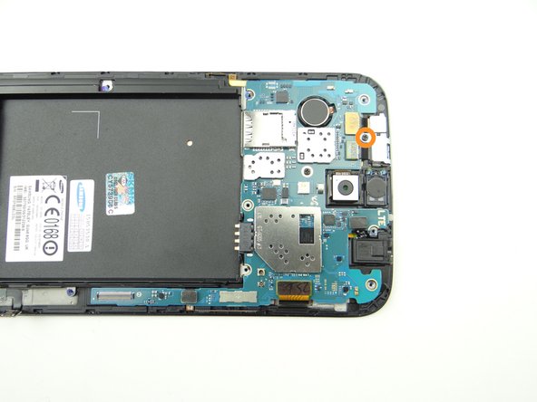 Picture 1: Remove 2.4 mm #00 Phillips screw from shield (covering front-facing camera and infrared sensor).  Place in SLOT 2.