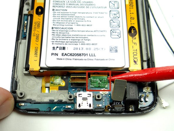 Picture 3: Use the pointed end of the spudger to lift the display cable up and out of the way.