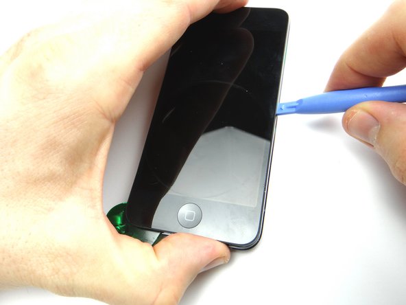 Using the blue pry tool, work your way around the perimeter of the iPod prying up as you go.