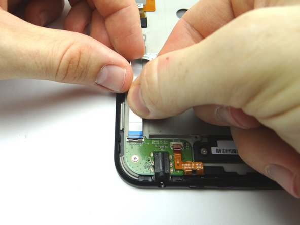 Push headphone jack connection cable into open ZIF connector.