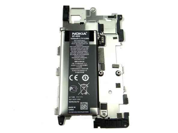 Wedge the flat end of the spudger at the center-bottom of the battery.  Push halfway up.