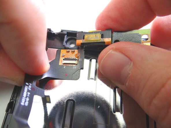 Picture 1: Push the flat end of spudger under earpiece speaker to free it from the adhesive.