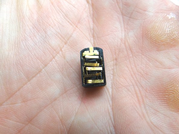 Use your fingers to continue peeling the headset jack free.