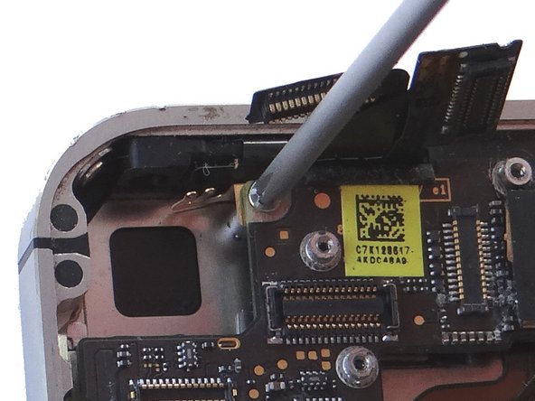 Be careful not to scratch the logic board with the tweezers.