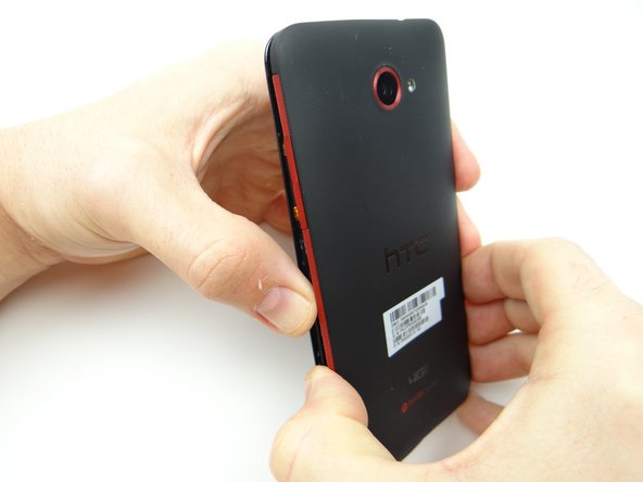 Picture 1: Use both hands to continue pulling the battery cover from the phone.