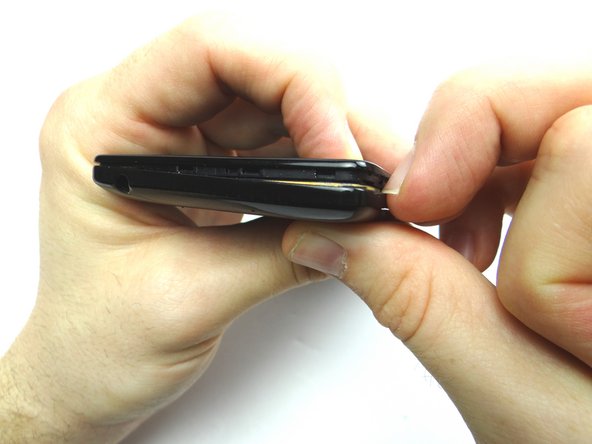 Do not try to remove the battery cover just yet!  The battery cover is held in place with adhesive.