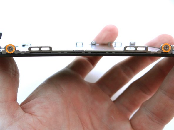 Replace two 1.2 mm Phillips screws from SLOT 7 on either side of LCD frame.