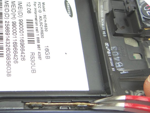 Use Curved Tip Tweezers to reattach the volume button contacts to the plastic tab.