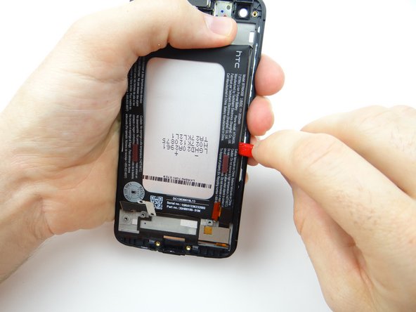 Picture 3: Pivot the spudger sideways to continue cutting through the adhesive.