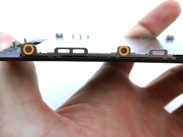 Replace two 1.2 mm Phillips screws from SLOT 7 on either side of LCD frame.