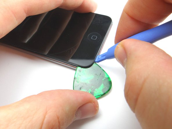 Wedge a guitar pick in the lower-left corner.