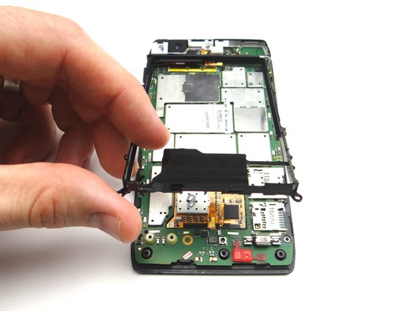 Lift the metal chassis from the logic board. Place in ZONE IV.