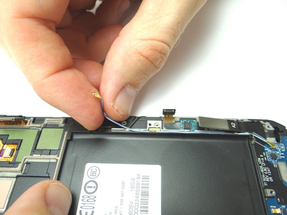 Route the cellular antenna cable along the right side of the front assembly.