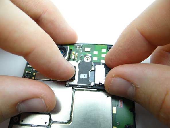 Seat the SIM/SD card tray in its socket on the logic board.