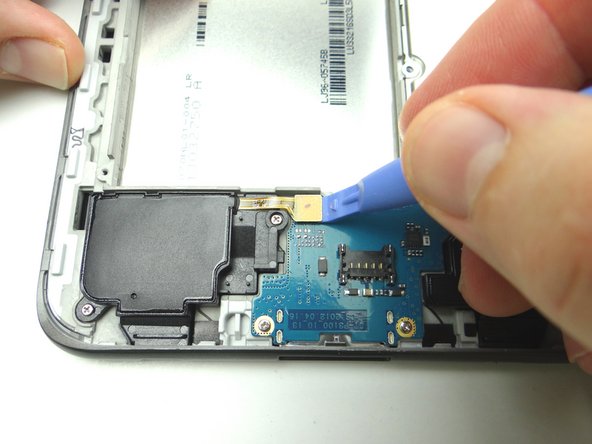 Use the blue pry tool to disconnect the left and right speakers.