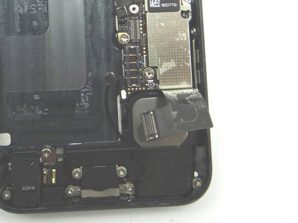 Picture 2 &amp; 3: The charging port assembly cable is adhered to the logic board – gently peel it free from the logic board, working top to bottom until cable is free of logic board. Be cautious as this cable is very fragile.