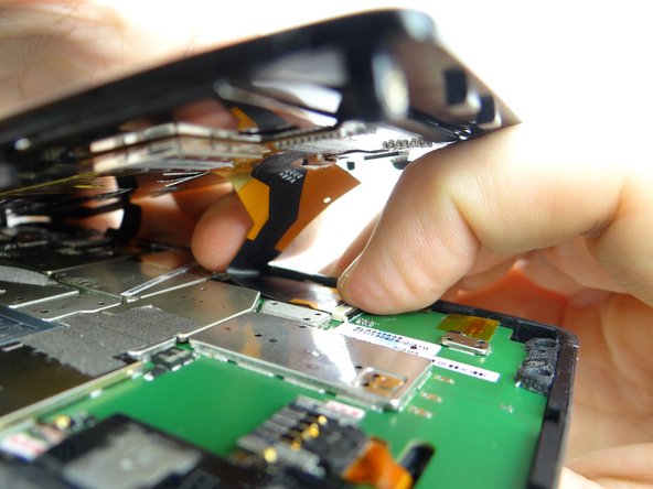 Picture 2: Guide display cable into open ZIF connector. Hold display cable in place with one hand, while closing ZIF connector with your thumb on opposite hand.