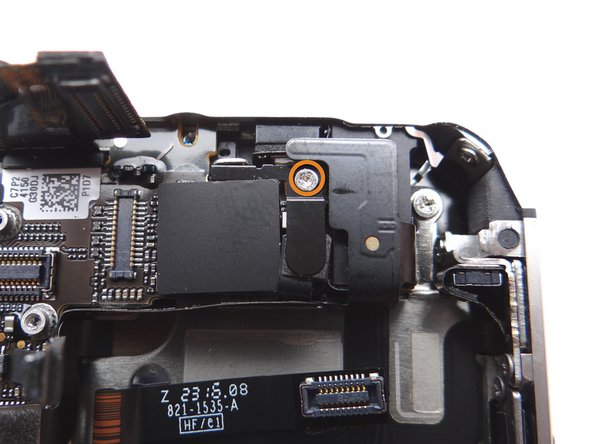 Picture 1: Remove the 1.5 mm Phillips screw securing the L-Shaped Antenna Shield to the logic board near the headphone jack.  Place the screw in SLOT 9.