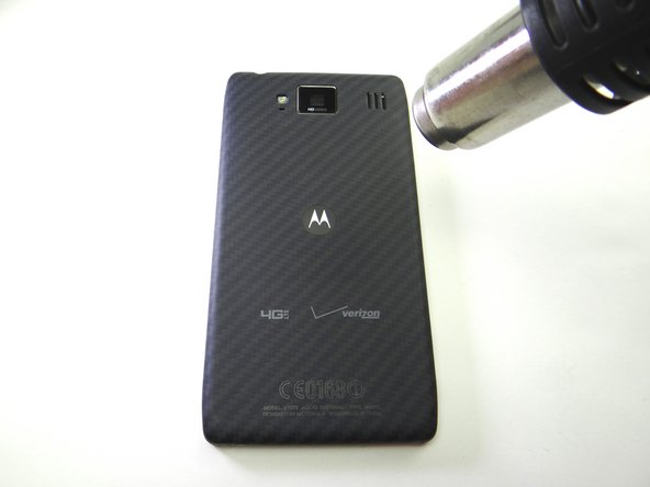 Picture 1: Apply low-level 100° Celsius heat to the battery cover to loosen the adhesive holding the battery in place.