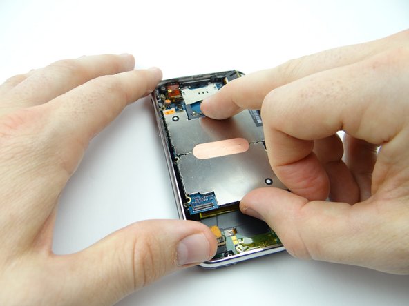 Picture 3: Hold the charging port cable out of the way while seating the bottom of the logic board.