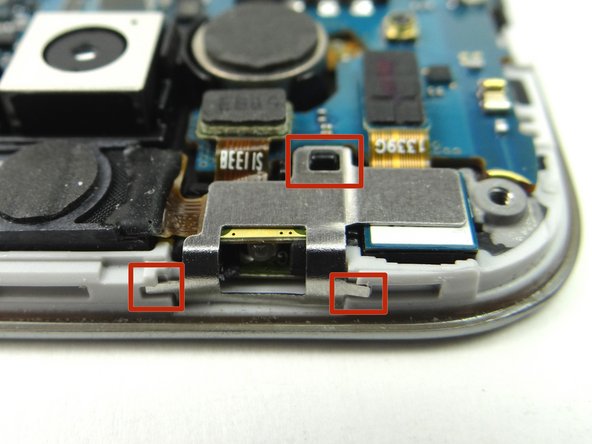 Use curved-tip tweezers to grab metal shield and work it around the tabs creating tension (marked in Picture 2).