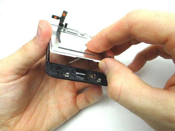 Grab the bottom edge of the LCD to lift it away from the glass digitizer.