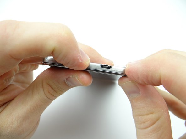 Snap the bottom edge in place first, pushing down on either side of the charging port.