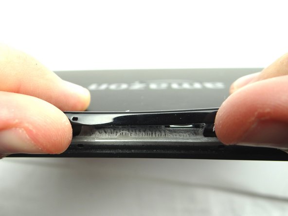 Gently lift the trim using your fingers to expose the remaining adhesive.