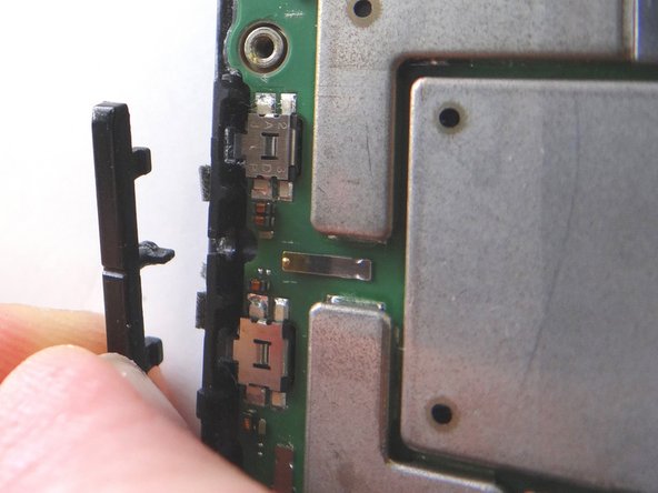 Gently peel the volume rocker clockwise to free it from the front panel.