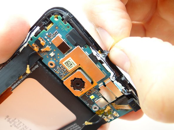 Peel up tape covering power button contact.